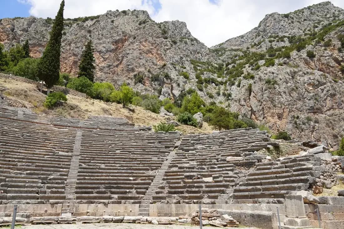 Ancient theater and temple ruins of Delphi above the valley on a private Greece tour