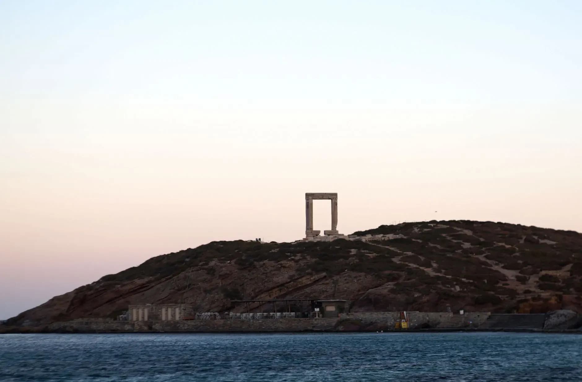 The Portara ancient marble gate of Naxos at sunset, Greece