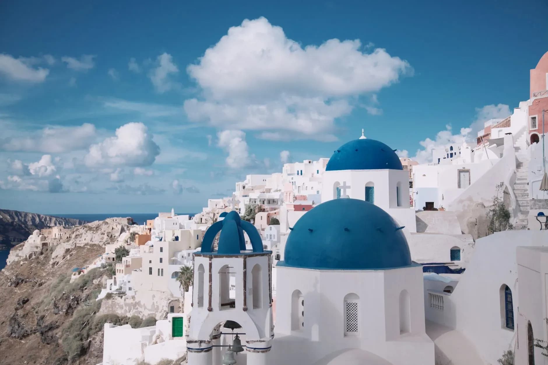Blue-domed churches of Oia above the Santorini caldera on a luxury Greece tour