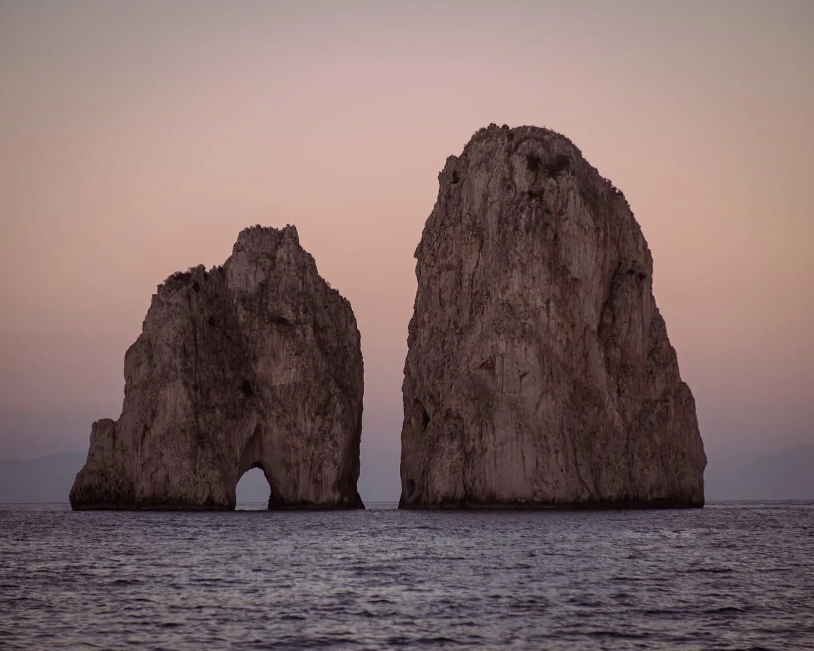 Faraglioni rocks off Capri seen from a private boat tour in Italy