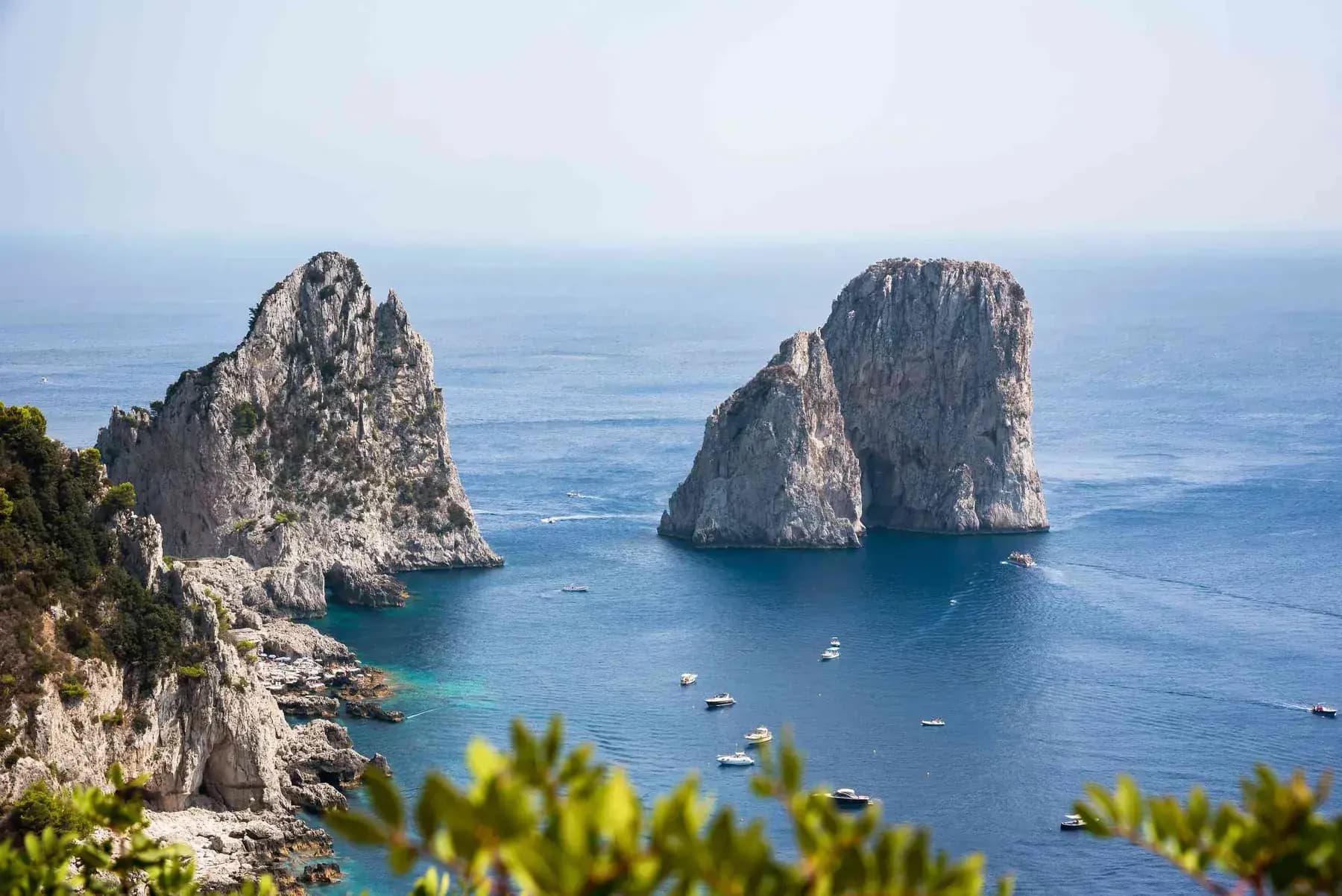 The Faraglioni sea stacks rising off Capri on an Italy and Greece journey