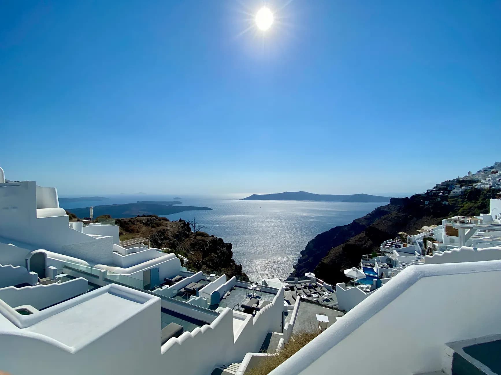 Whitewashed houses above the Santorini caldera at sunset on a luxury Europe tour