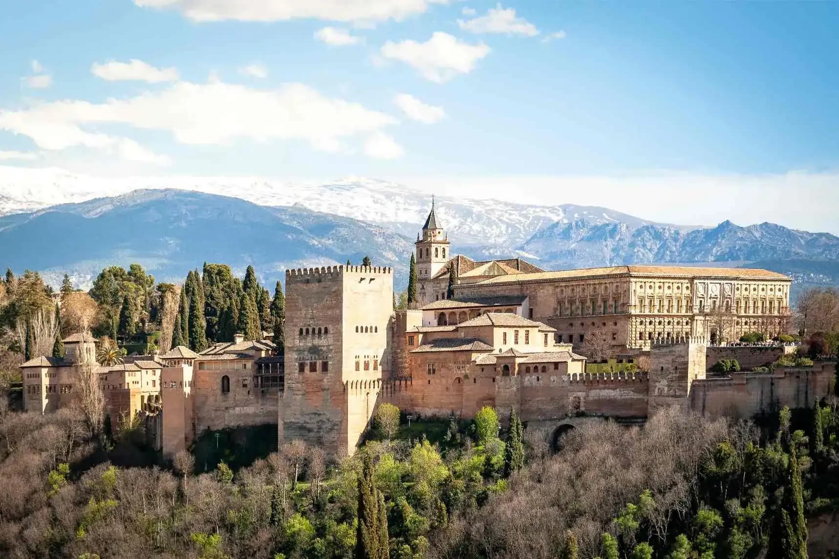 The Alhambra palace with the snow-capped Sierra Nevada behind it in Granada, Spain