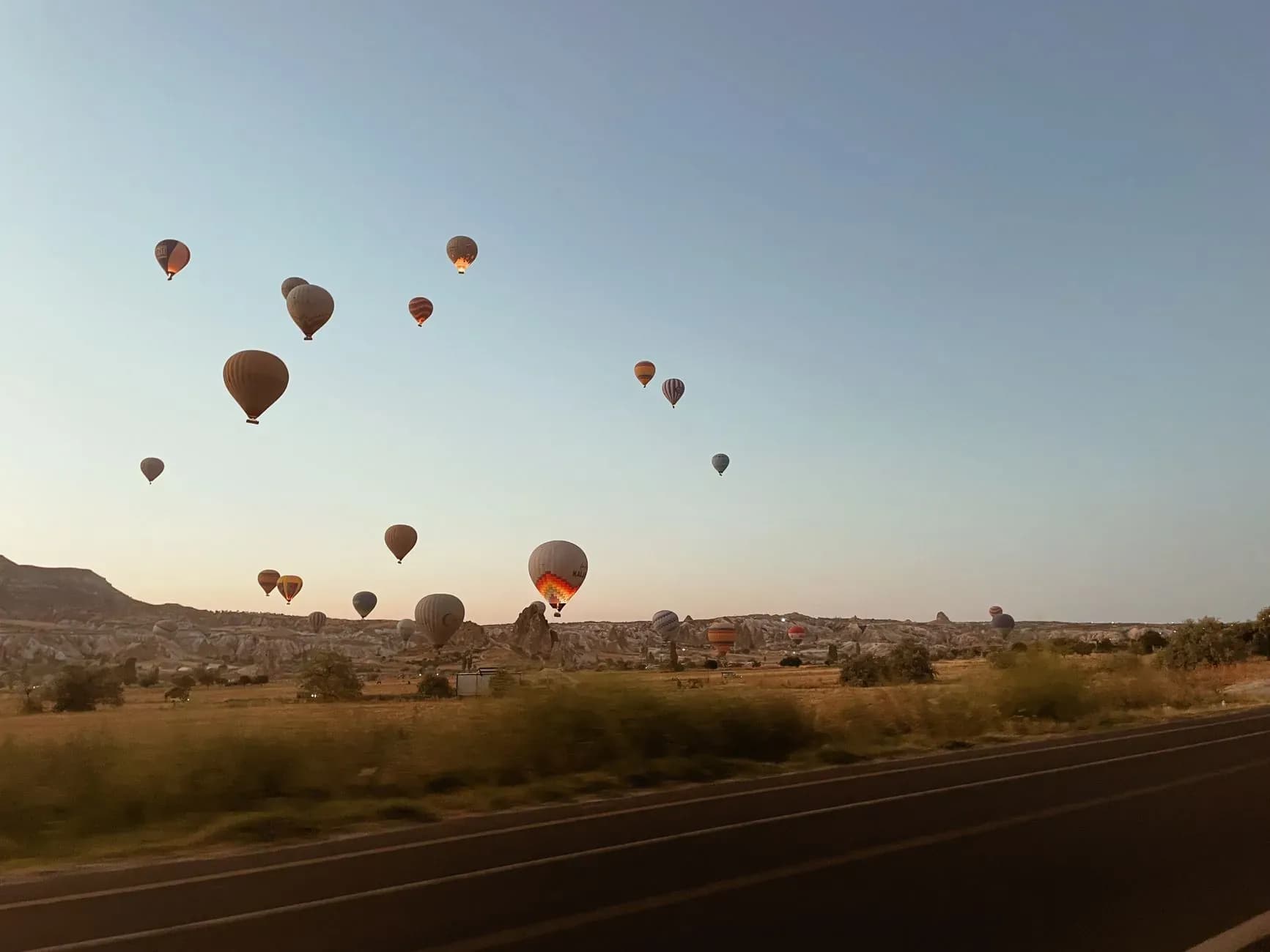 Couple watching hot air balloons from a cave hotel terrace in Cappadocia on a Turkey honeymoon