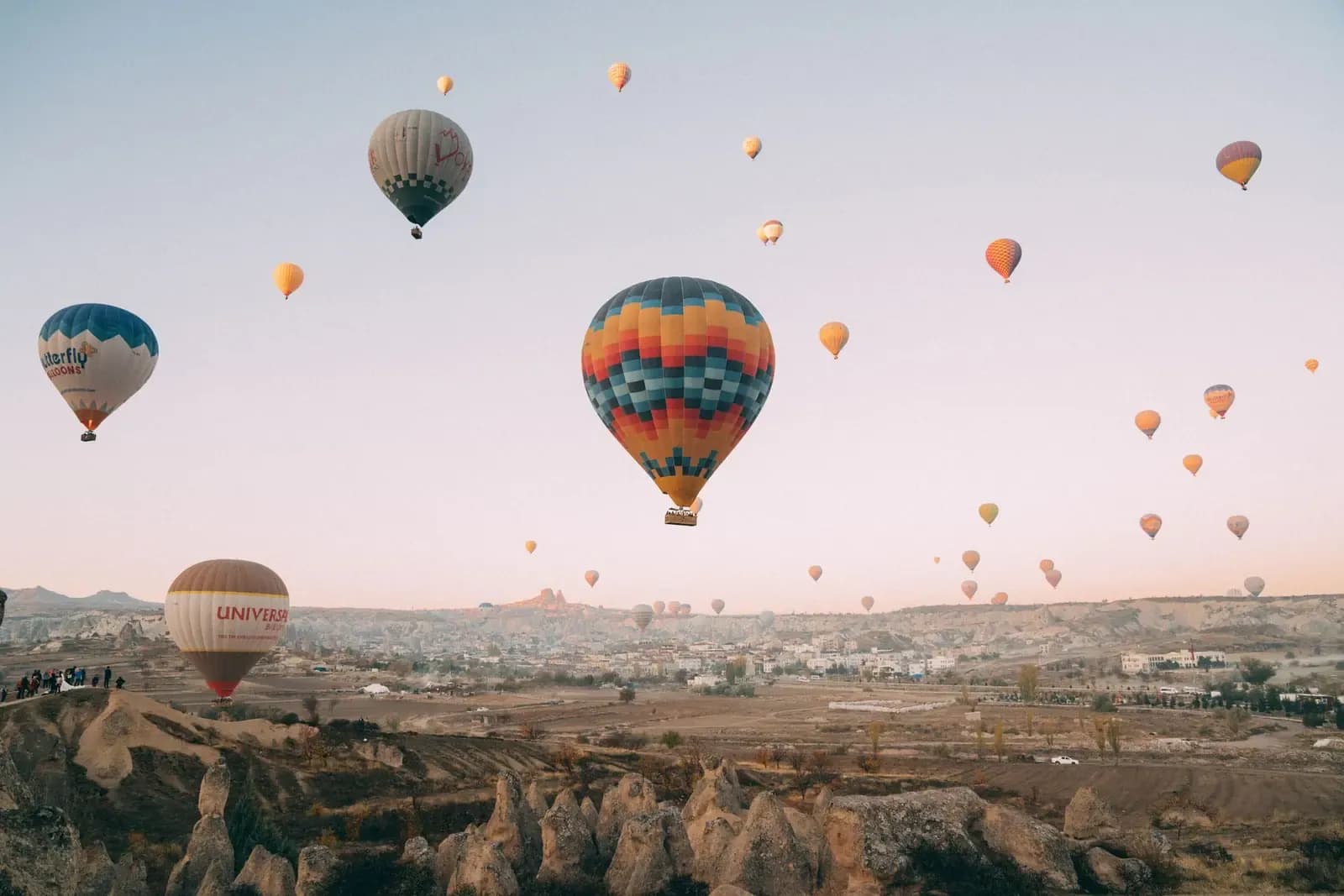Hot air balloons over the fairy chimneys of Cappadocia at sunrise on a private luxury Turkey tour