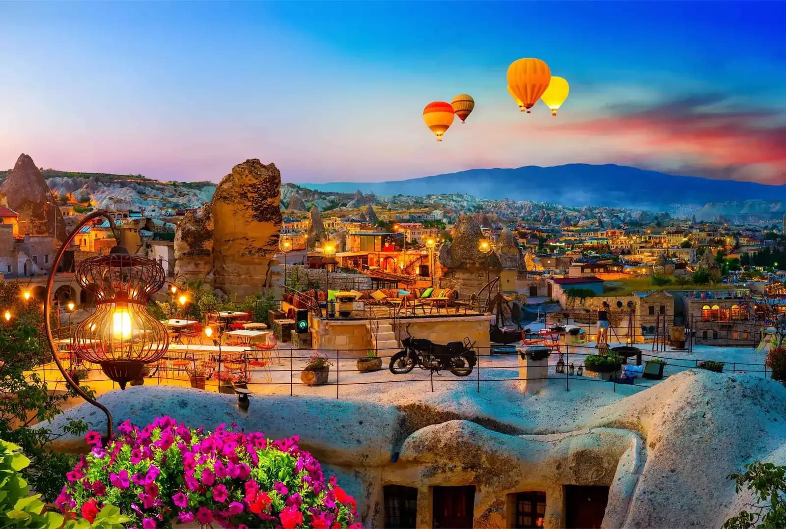 Cappadocia's cave villages and hot air balloons in the evening light, Turkey