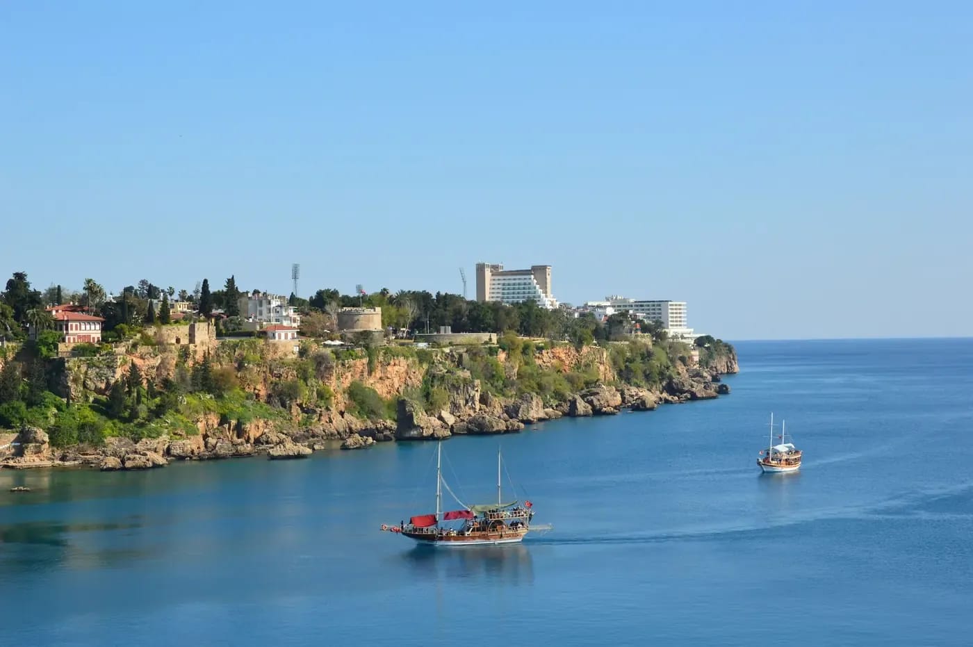 Turquoise Mediterranean water and pine-covered cliffs on the Antalya coast of southern Turkey