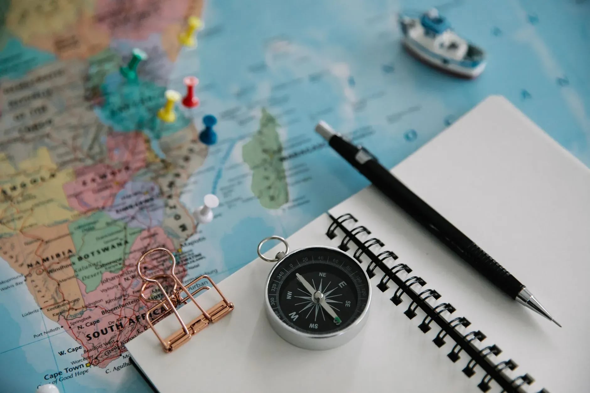 Travel designer planning a custom journey over maps and notes