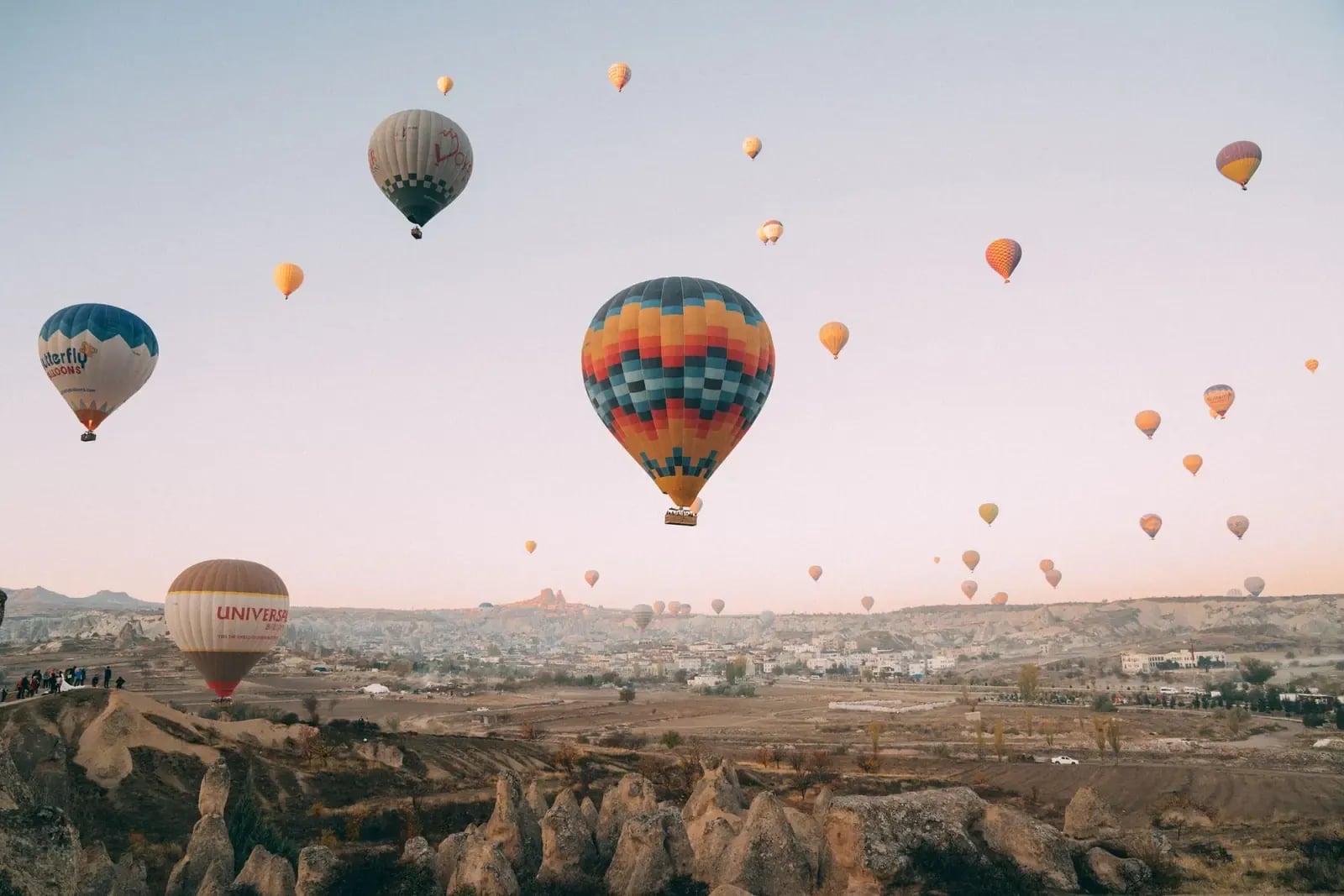 Sunrise hot air balloon flight over Cappadocia's valleys
