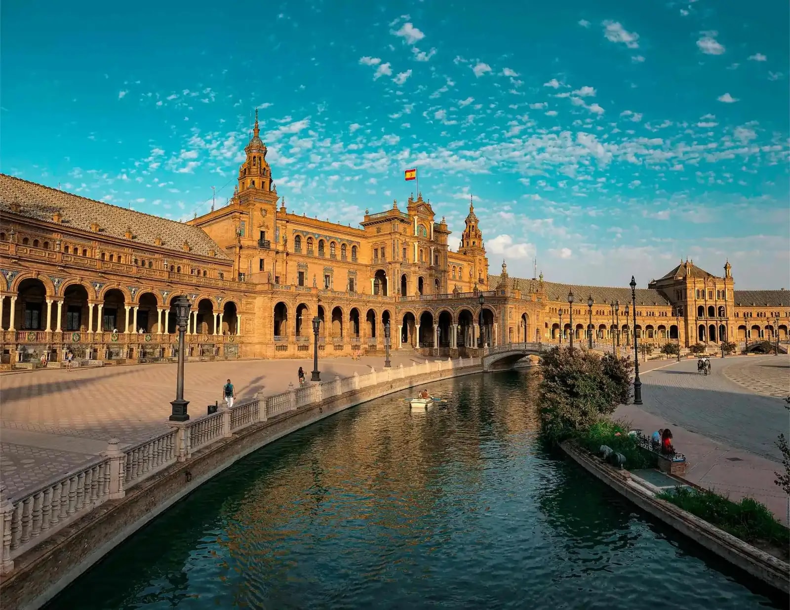 Plaza de España in Seville with tiled bridges and a turquoise sky, Spain