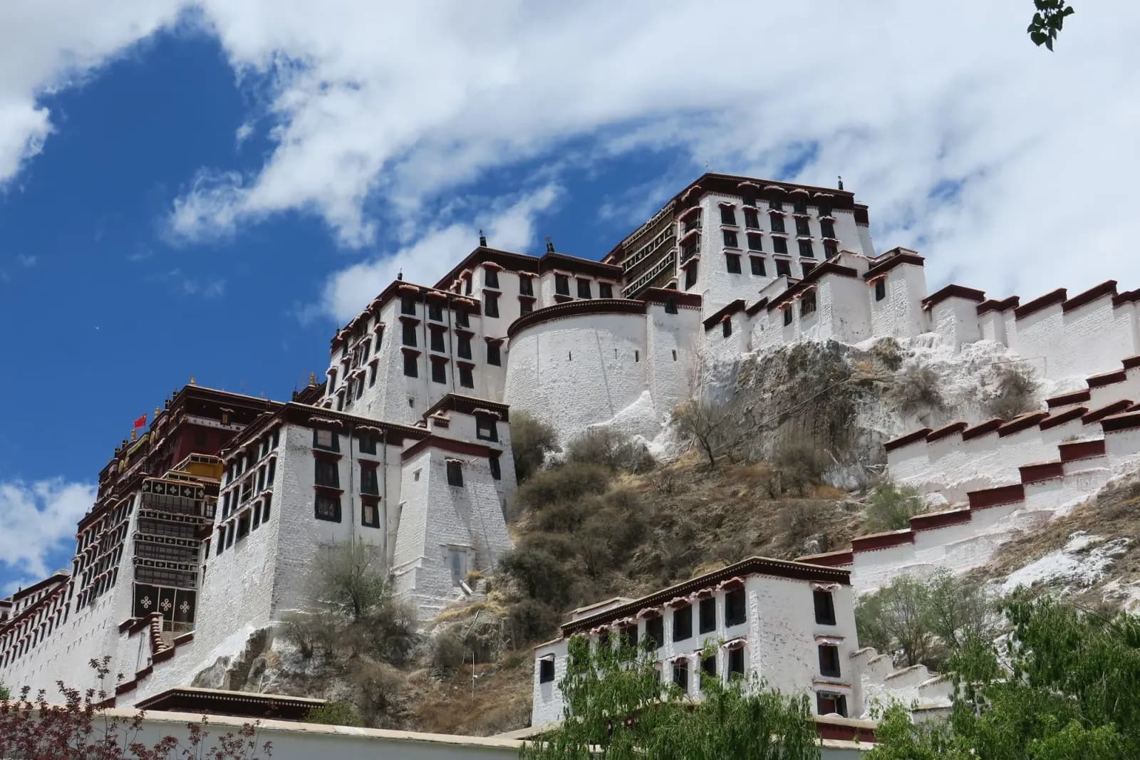 The white and ochre walls of the Potala Palace rising above Lhasa, Tibet