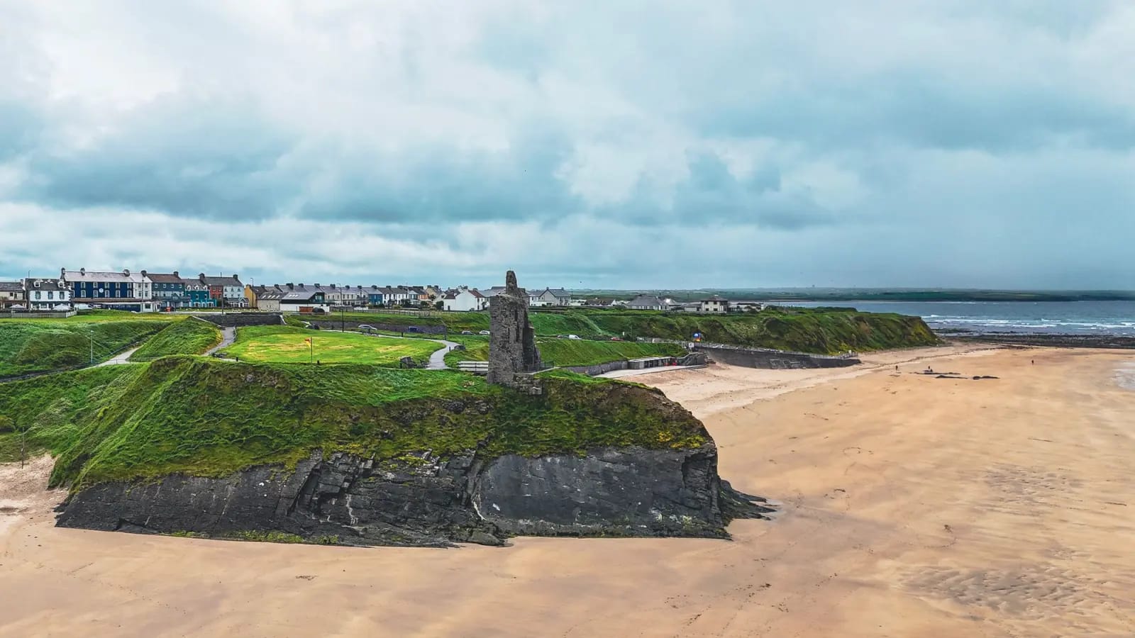 Ballybunion castle ruin above the beach and Atlantic coastline in County Kerry, Ireland